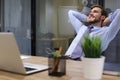 Smiling handsome businessman relaxing in a modern office Royalty Free Stock Photo