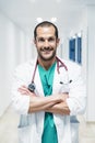 Smiling handsome doctor at hospital. Standing. Royalty Free Stock Photo