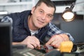 smiling handsome electrician checking electrical system Royalty Free Stock Photo