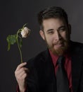 Smiling Handsome Goatee Man Holding Withered Rose