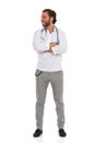 Smiling Handsome Male Doctor Is Standing With Arms Crossed And Looking Away. Front View Royalty Free Stock Photo