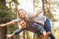 Smiling handsome man giving piggy back to his girlfriend Royalty Free Stock Photo