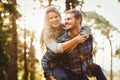 Smiling handsome man giving piggy back to his girlfriend Royalty Free Stock Photo