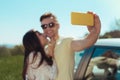 Smiling handsome man holding his yellow smart phone