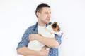 A smiling handsome man holding a purebred dog on a white background. The concept of people and animals. young man holding his dog