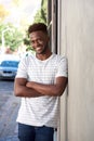 Smiling handsome man leaning on wall outside on street Royalty Free Stock Photo