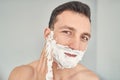 Pleasant attractive young male doing skincare routine at home Royalty Free Stock Photo