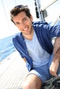 Smiling handsome man on a sailing boat