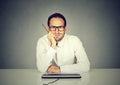 Smiling handsome man sitting in front of computer keyboard Royalty Free Stock Photo