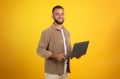 Smiling handsome millennial european guy use laptop for marketing, business