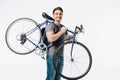 smiling handsome student holding bicycle on shoulder