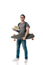 smiling handsome student holding books and skate Royalty Free Stock Photo