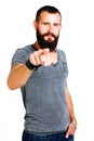 Smiling handsome Tattooed bearded man pointing at you