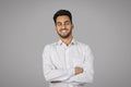 Smiling Handsome Young Arab Businessman With Folded Arms Standing Over Grey Background Royalty Free Stock Photo