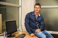 Smiling handsome young businessman sitting at desk Royalty Free Stock Photo