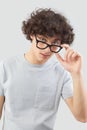 Smiling and handsome, the young man wears glasses. He looks into the camera with his blue eyes, man portrait with eyeglasses Royalty Free Stock Photo