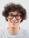 Smiling and handsome, the young man wears glasses. He looks into the camera with his blue eyes, man portrait with eyeglasses Royalty Free Stock Photo