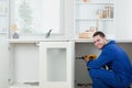 Smiling handyman fixing a door