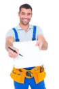 Smiling handyman giving clipboard for signature Royalty Free Stock Photo