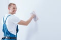 Smiling handyman priming substrate Royalty Free Stock Photo