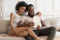 Smiling happy african american family spouse using digital tablet.