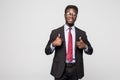 Smiling happy african black executive professional giving a thumbs up in studio