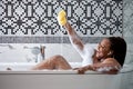 Smiling happy african woman clean fresh healthy black skin spa treatment enjoy relaxing taking shower and bath Royalty Free Stock Photo