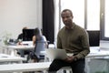 Smiling happy afro american businessman sitting on his desk Royalty Free Stock Photo