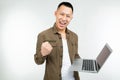 Smiling happy asian man holding a laptop in his hands on a white studio background Royalty Free Stock Photo