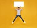 Smiling happy Asian man jumping and holding blank speech bubbles on yellow background. advertise announcement concept Royalty Free Stock Photo