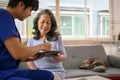 Smiling Asian old lady patient has a medical checkup with her doctor at the clinic Royalty Free Stock Photo