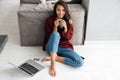 Smiling happy asian woman drinking cup of coffee Royalty Free Stock Photo