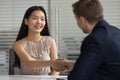 Smiling happy asian young professional shaking hands with hr manager. Royalty Free Stock Photo