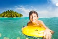 Smiling happy boy on body board swim in the sea