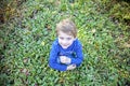 Smiling happy boy sitting in grass outside Royalty Free Stock Photo