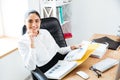 Smiling happy businesswoman holding reports and looking at camera Royalty Free Stock Photo