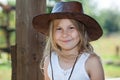 Smiling and happy Caucasian girl in leather cowboy hat portrait, long blond hair, brown eyes Royalty Free Stock Photo