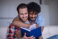 Man with a textbook embraced by his romantic boyfriend Royalty Free Stock Photo