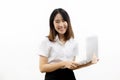 Smiling happy and cheerful Asian female formal dress holding a laptop notebook isolated over white background. Royalty Free Stock Photo