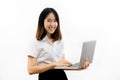 Smiling happy and cheerful Asian female formal dress holding a laptop notebook isolated over white background. Royalty Free Stock Photo