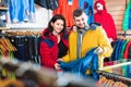 Couple examining track jackets in sports clothes store Royalty Free Stock Photo