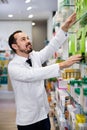 Male pharmacist looking for right medicine Royalty Free Stock Photo