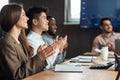 Smiling happy colleagues having training in boardroom, clapping hands Royalty Free Stock Photo