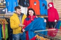 Couple examining track jackets in sports clothes store Royalty Free Stock Photo