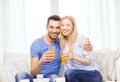 Smiling happy couple at home drinking juice Royalty Free Stock Photo