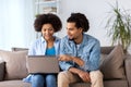 Smiling happy couple with laptop at home Royalty Free Stock Photo