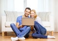 Smiling happy couple with laptop at home Royalty Free Stock Photo