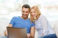 Smiling happy couple with laptop at home Royalty Free Stock Photo