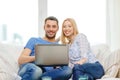 Smiling happy couple with laptop at home Royalty Free Stock Photo