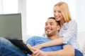 Smiling happy couple with laptop at home Royalty Free Stock Photo